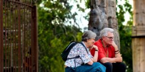 A senior couple enjoying a barrier-free historic architecture site with accessible pathways.