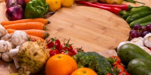 A colorful arrangement of flavonoid-rich fruits and vegetables on a wooden surface.