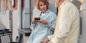 A senior couple enjoying a relaxed coffee break in a European historic square.