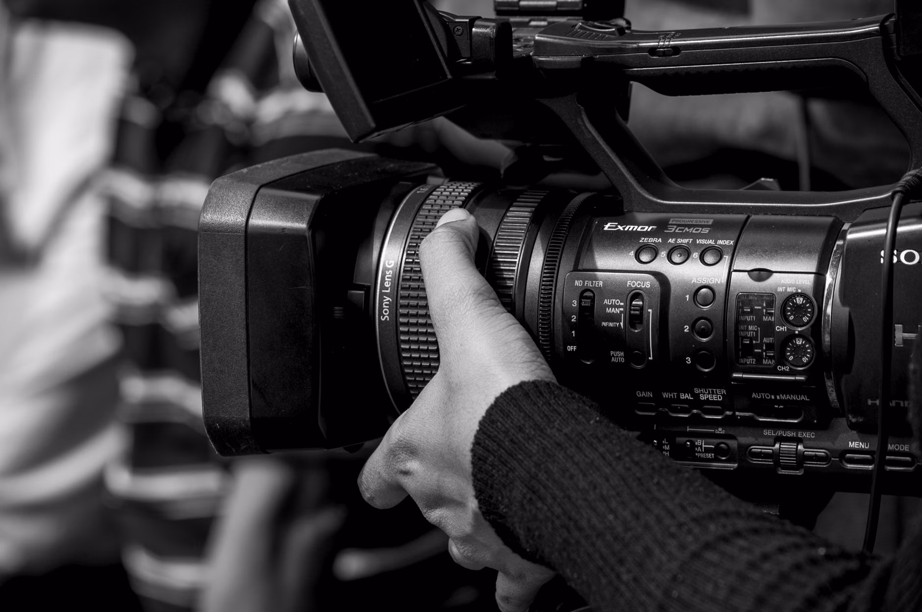 Close-up of hands operating a camera dial.