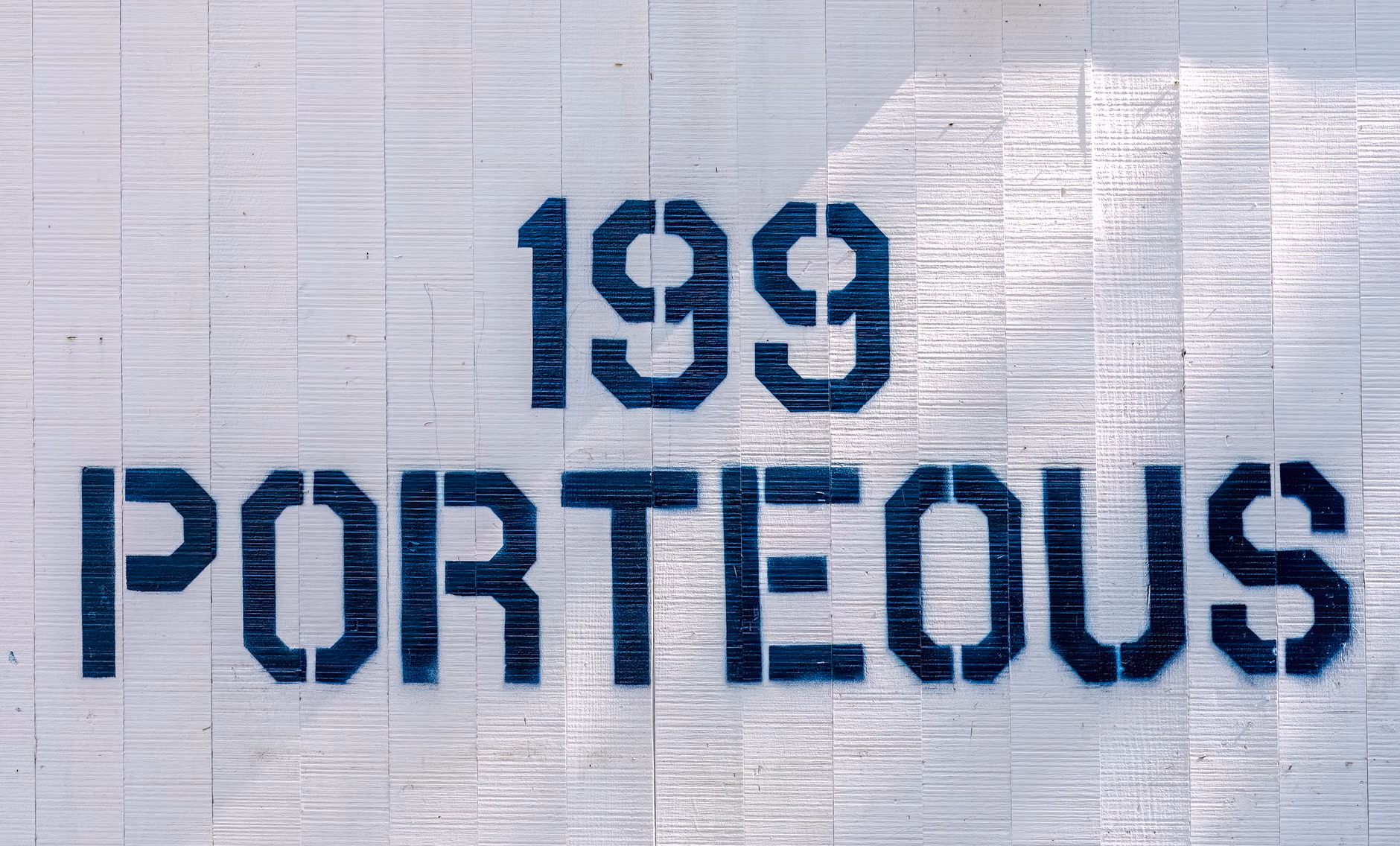 High-contrast, large-font pedestrian street sign.