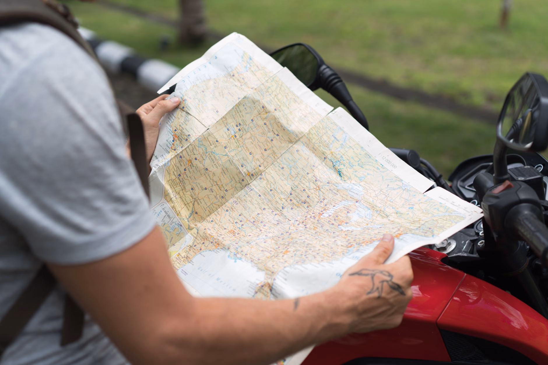 A senior traveler checking a map and smartphone for tour information.