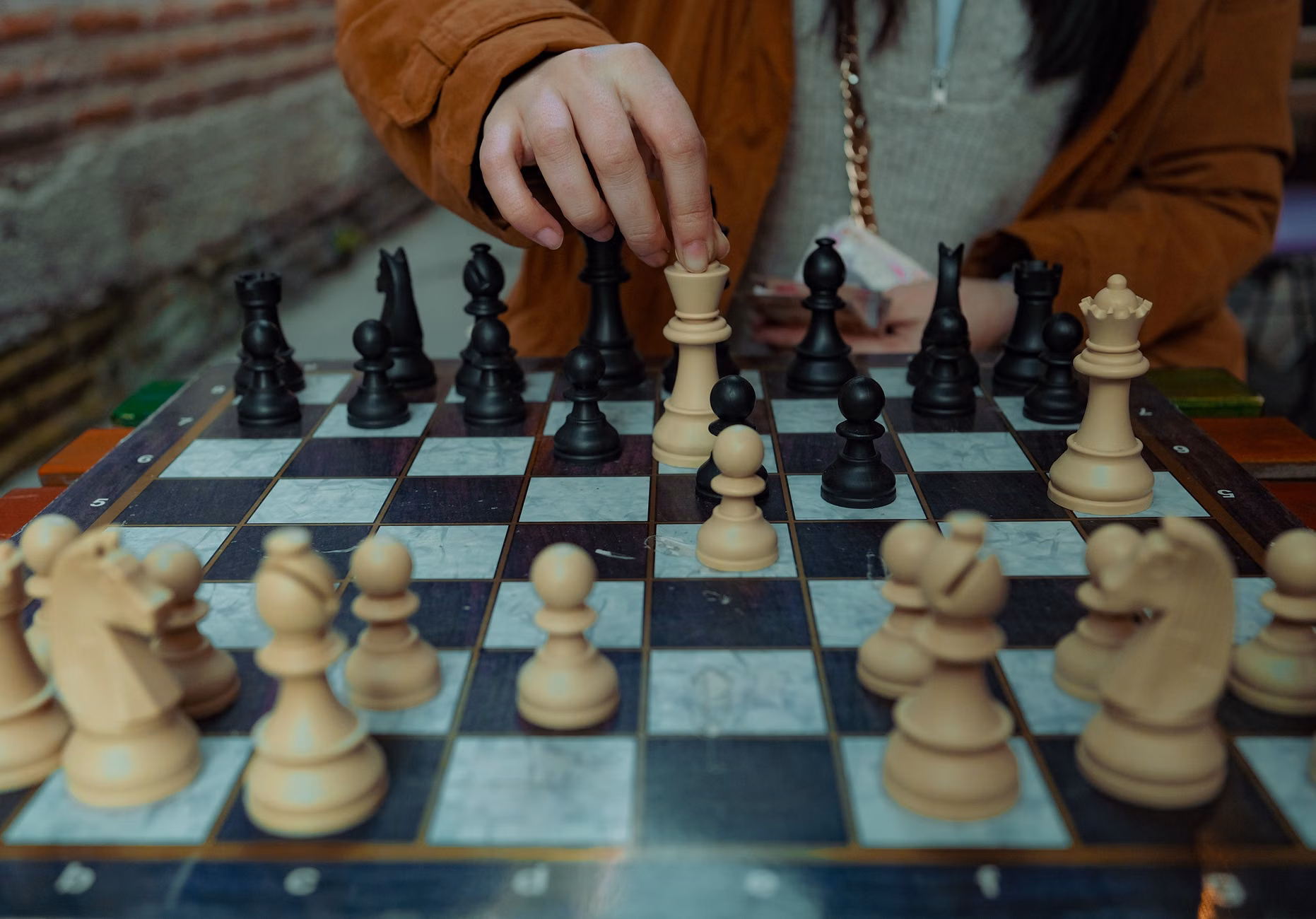 Close-up of hands playing chess.