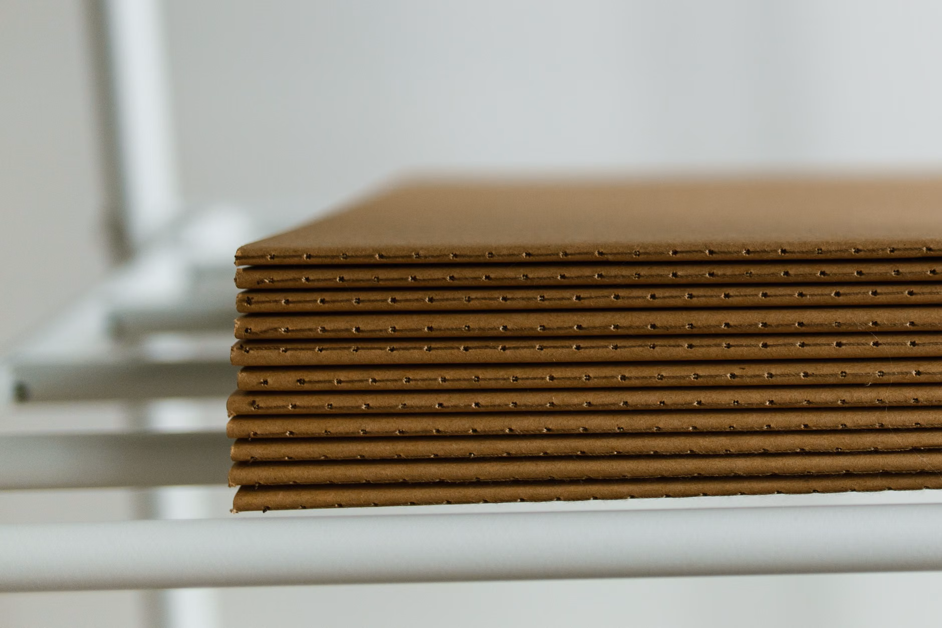 A wooden flower press kit with layers of cardboard.
