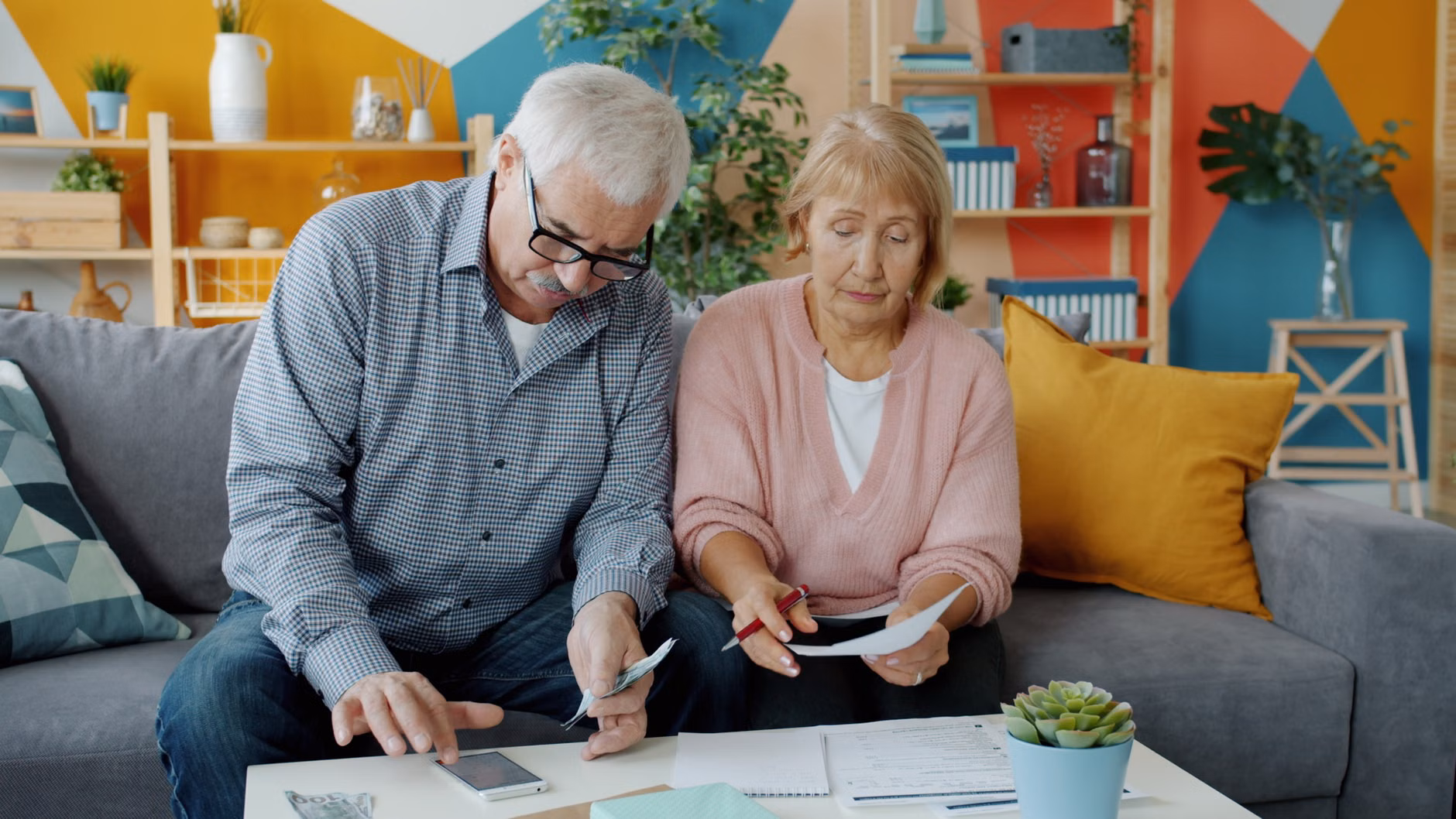 An older adult confidently managing finances on a tablet at home.