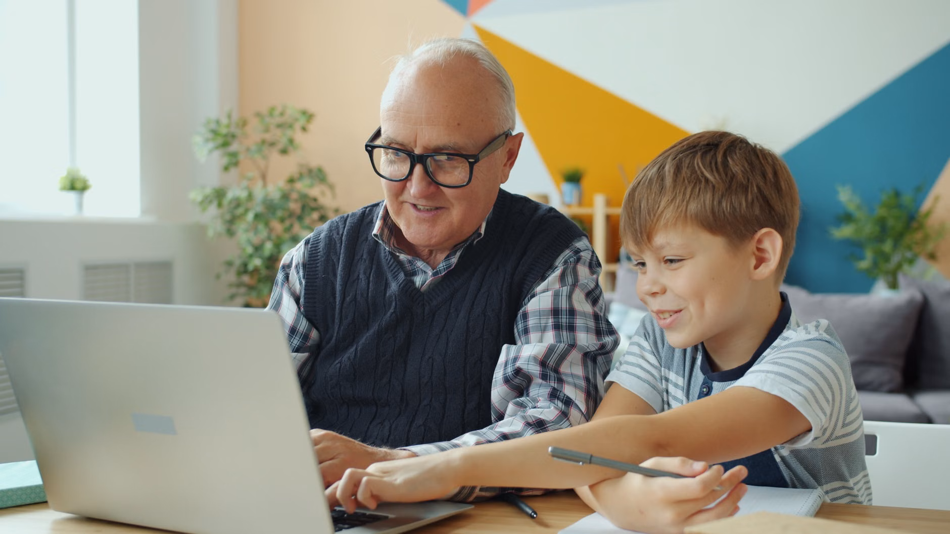 The 2026 Shift: Navigating Digital Intergenerational Mentorship 1 A senior mentor guiding a young adult on a digital task.