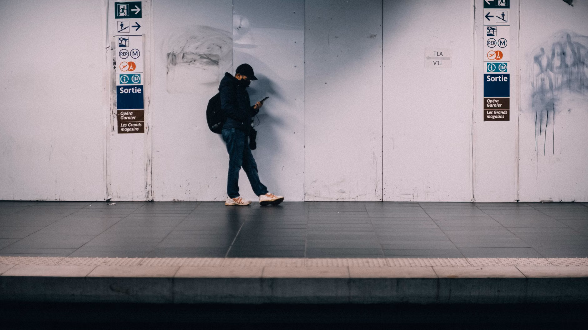 A senior person navigating a train station using a mobile app to find an elevator.