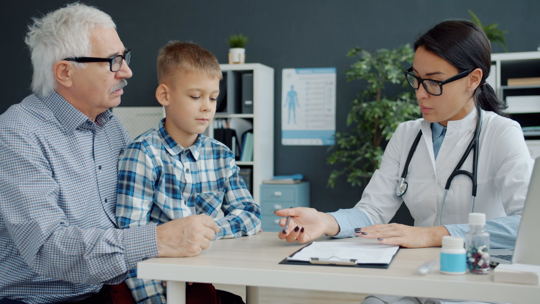 A caregiver and a senior reviewing health information on a mobile device.