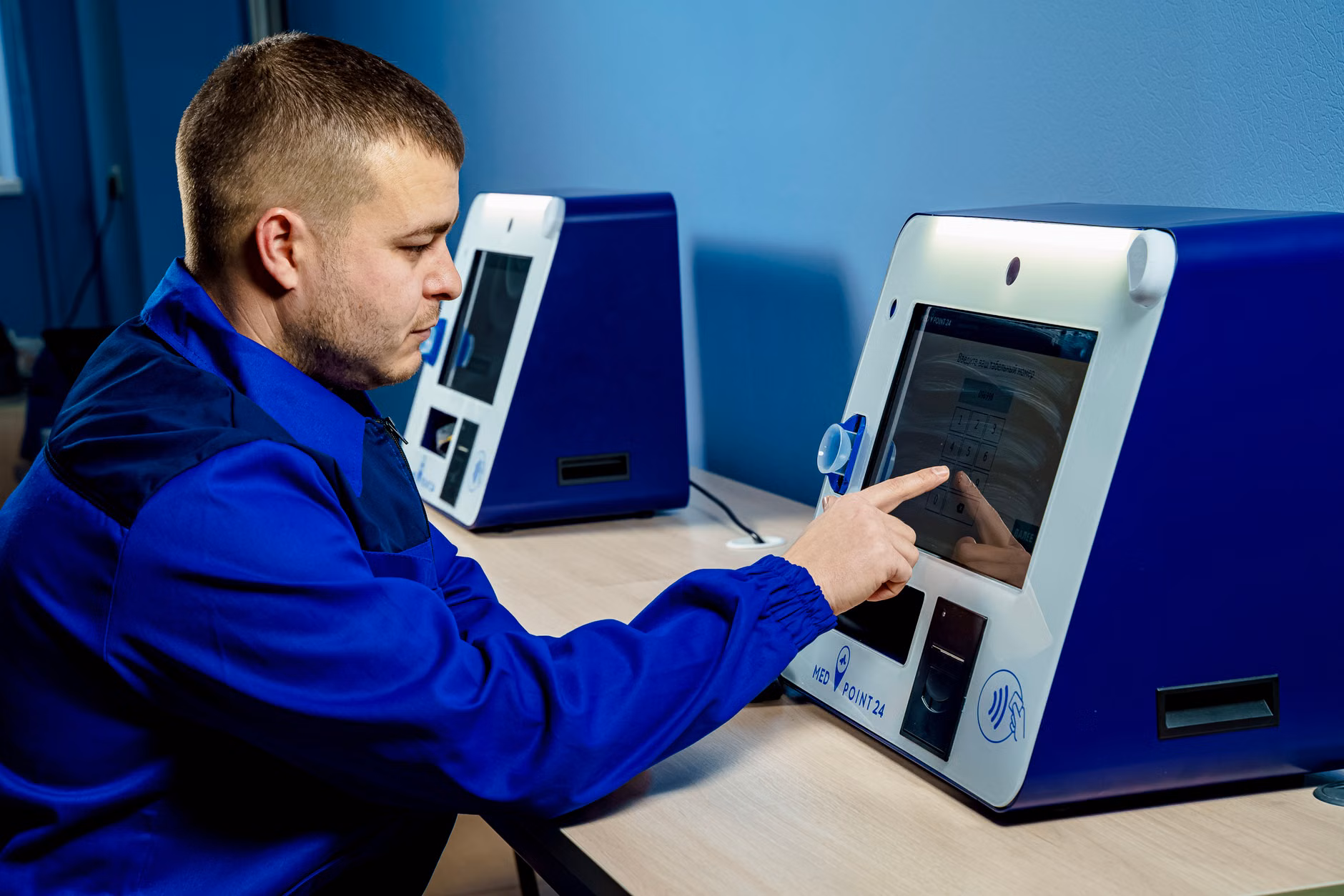 User interacting with a digital accessible information kiosk.