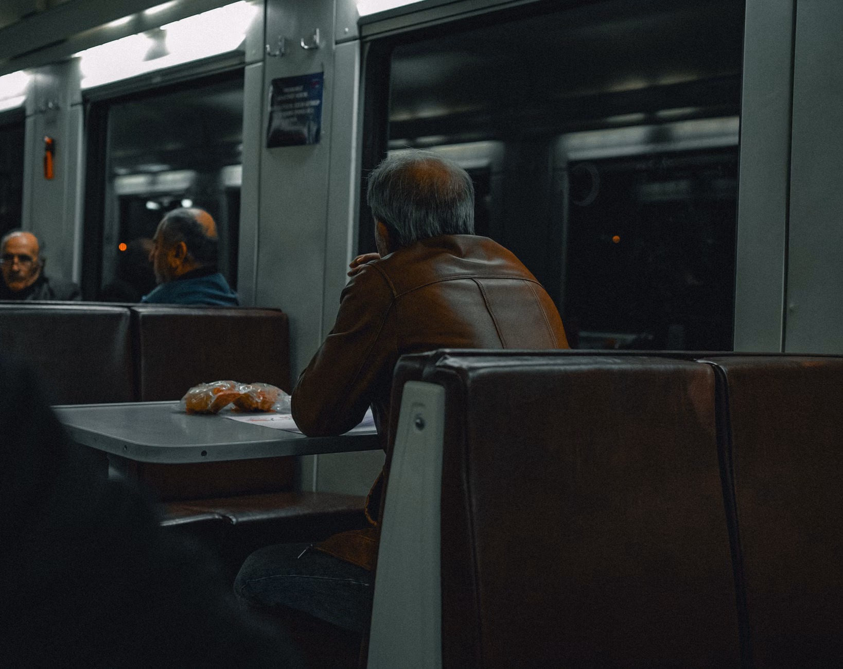 The Senior Traveler’s Guide to Overnight Train Journeys: Packing and Preparation Strategies 2 A senior traveler comfortably seated on a train wearing compression socks.