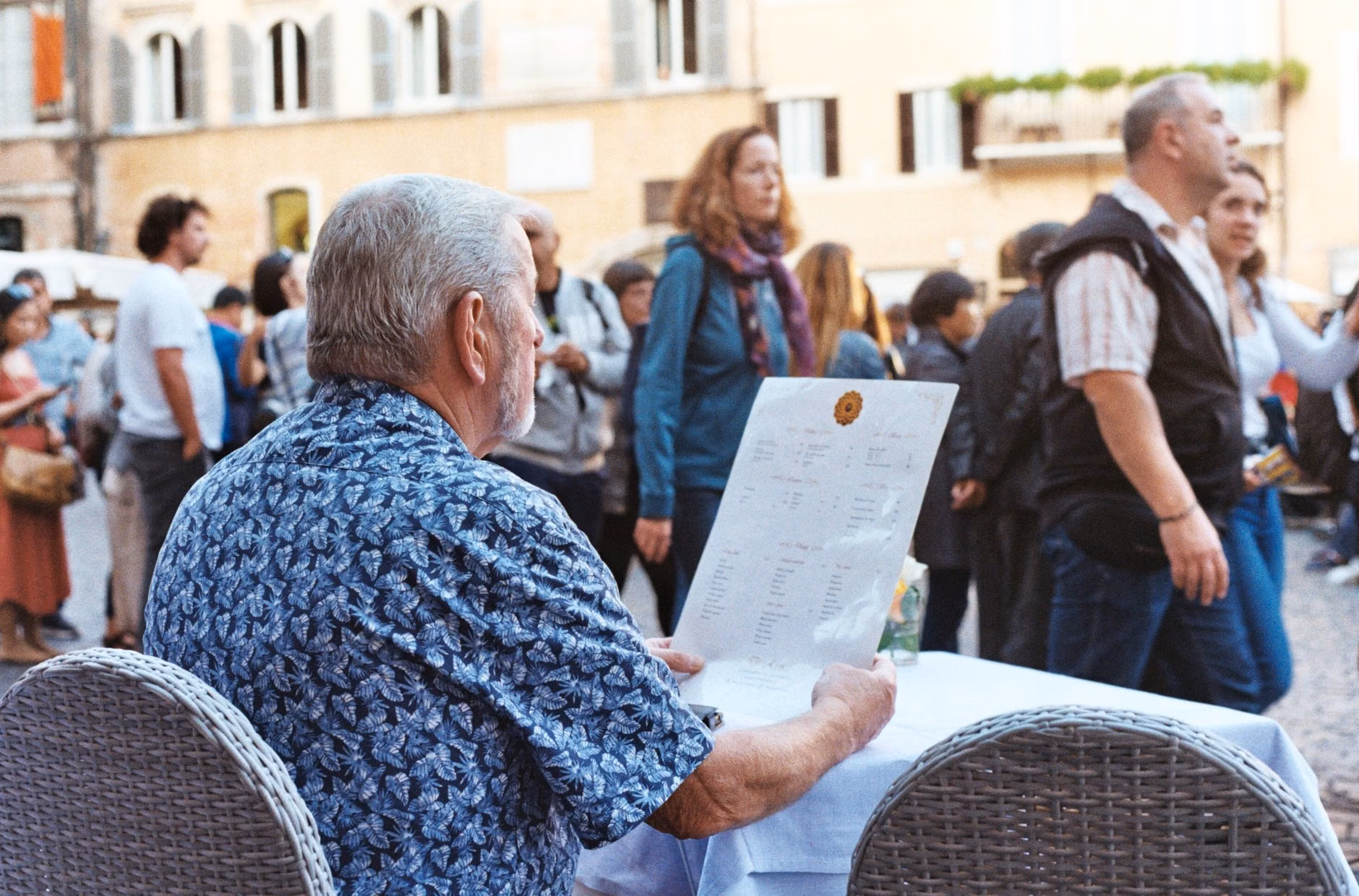 Travel Confidence: Mastering Digital Translation Tools for Senior Travelers 3 A senior traveler reading a translated menu on a tablet.