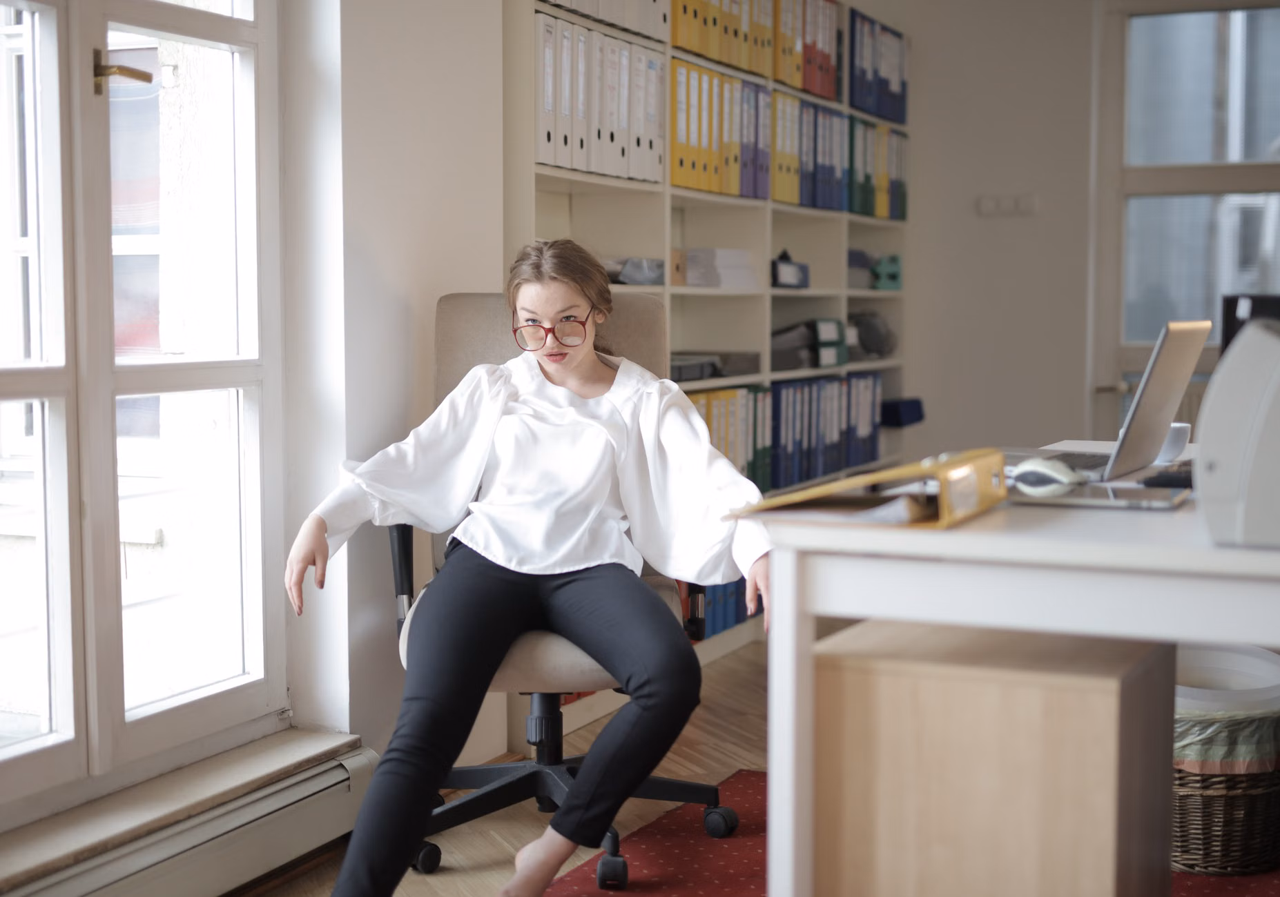 Proper seated posture in a chair to ensure safety during foot exercises.