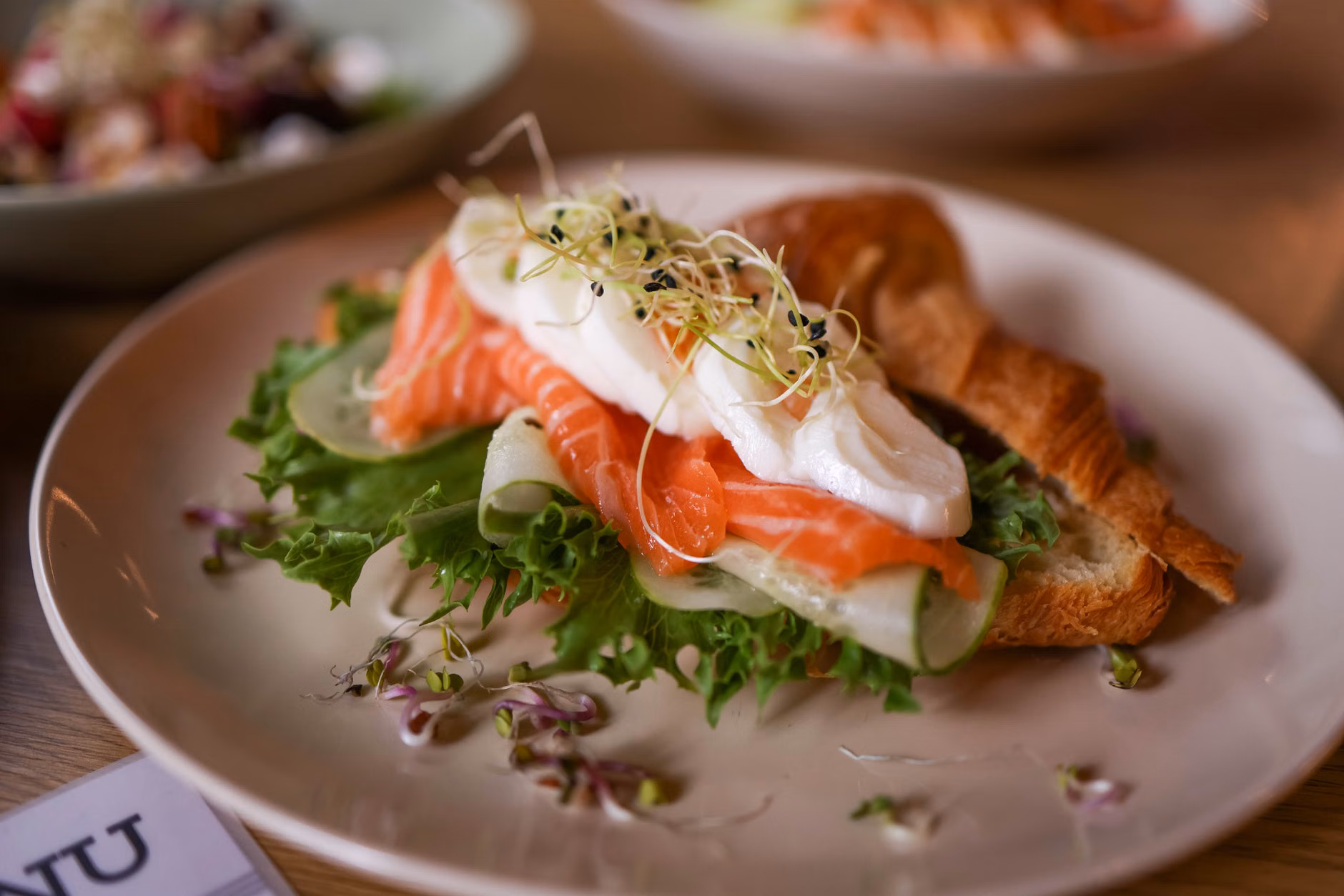 A nutritious dinner plate featuring salmon and dark leafy greens.