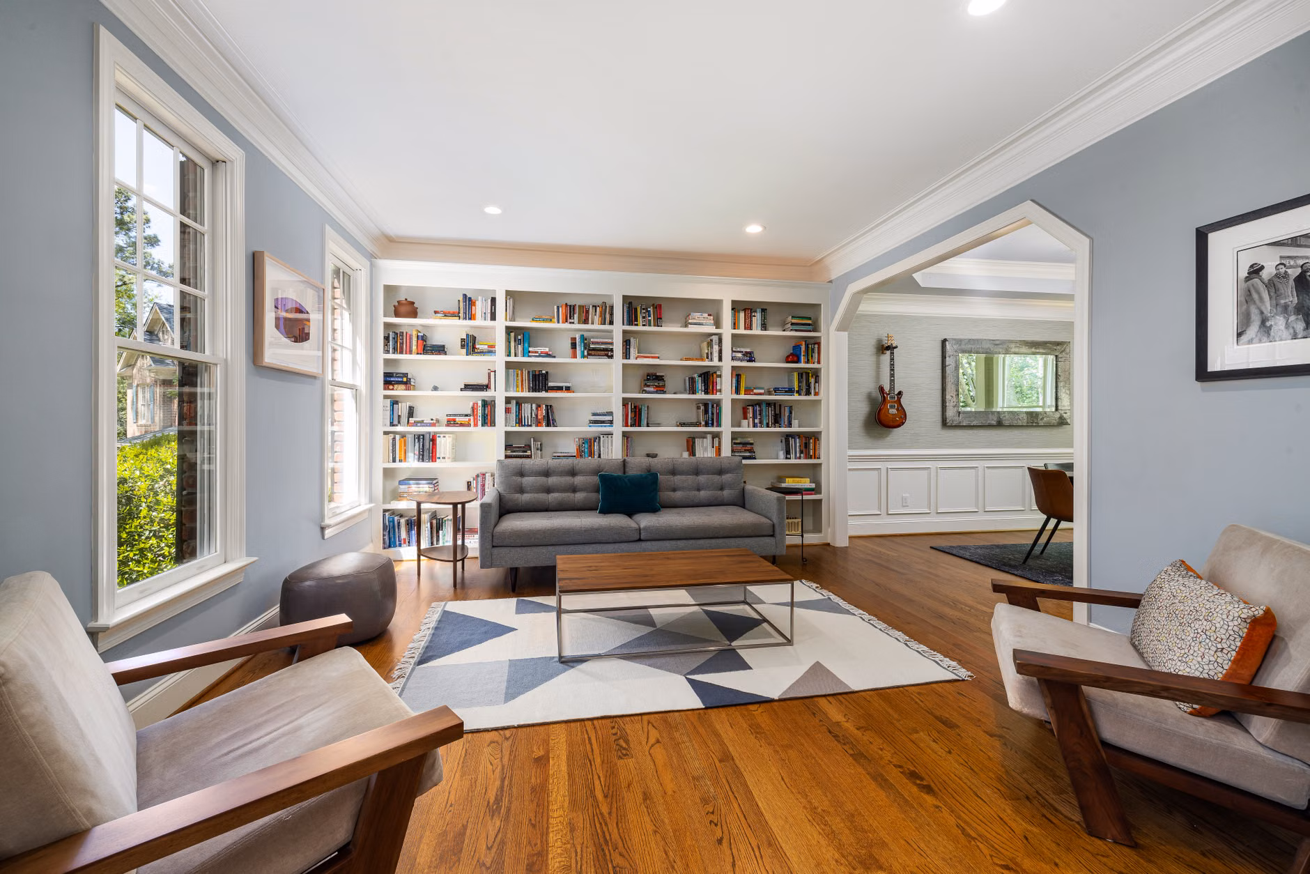 A spacious, accessible library lounge featuring wide paths and varied shelving heights.