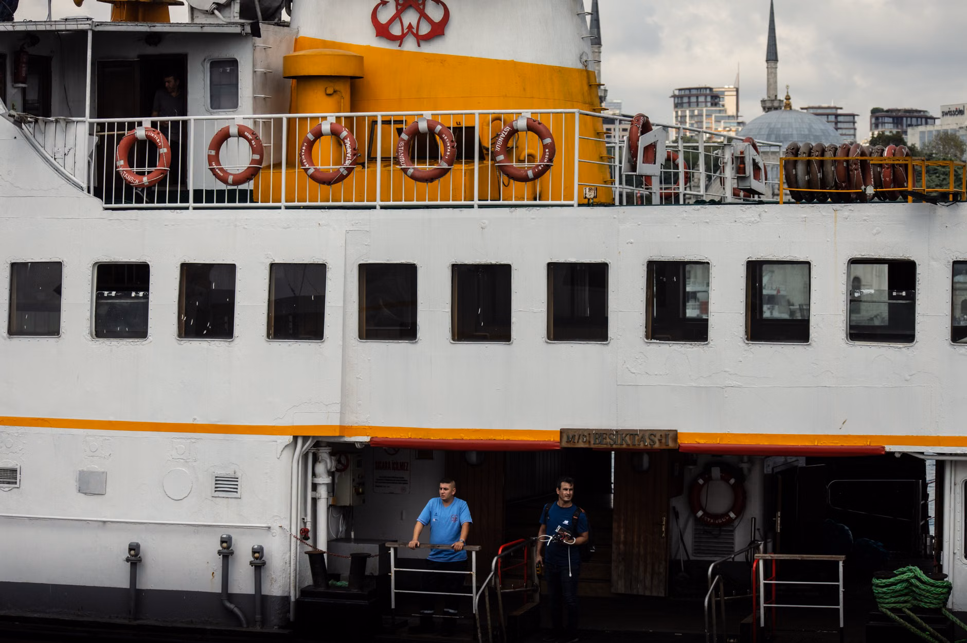 Navigating Cruise Ship Gangways: A Practical Guide to Accessible Boarding 3 A cruise ship staff member assisting a passenger near an accessible boarding gate.