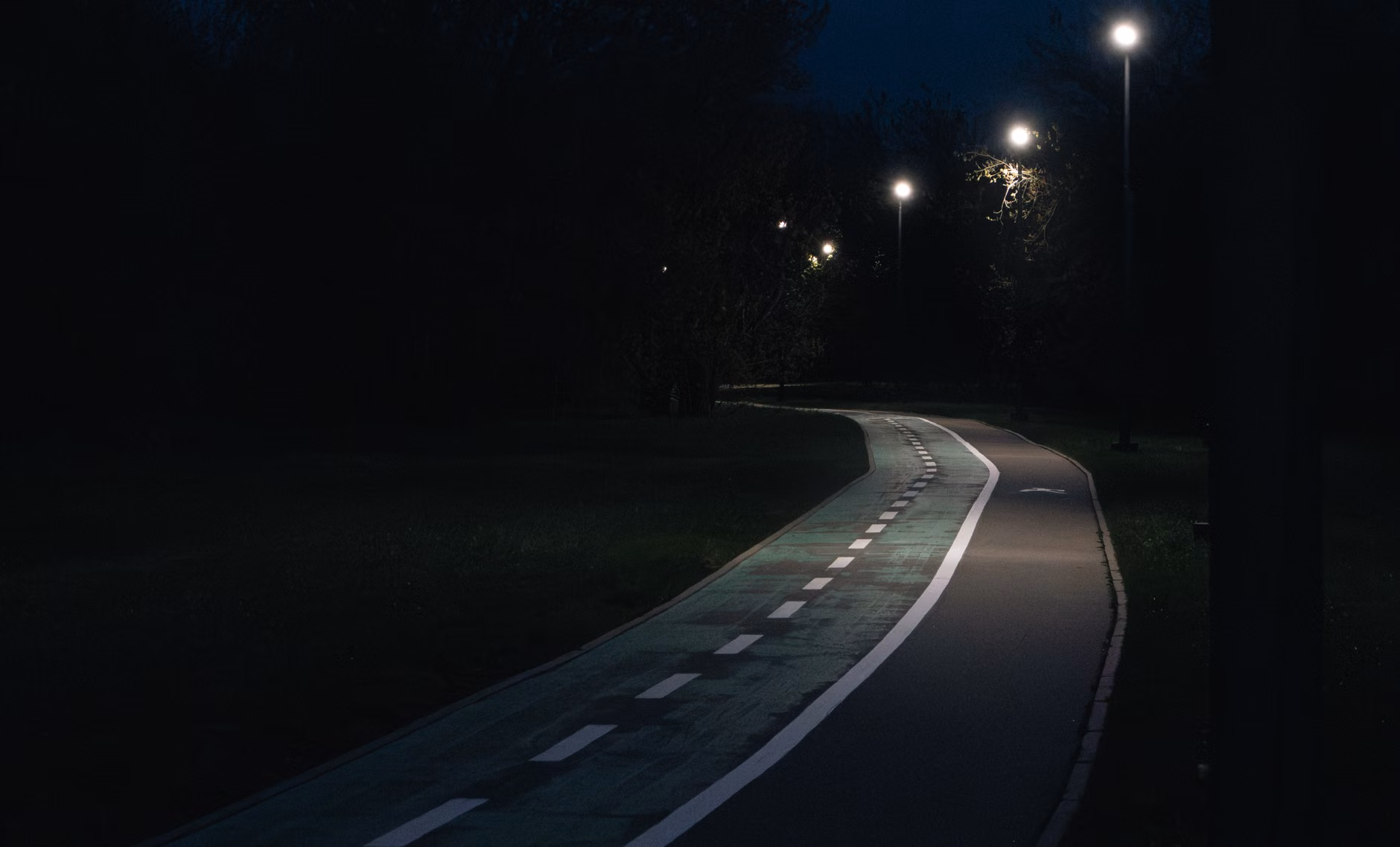 A well-lit, safe park path designed to enhance visibility for evening walking.