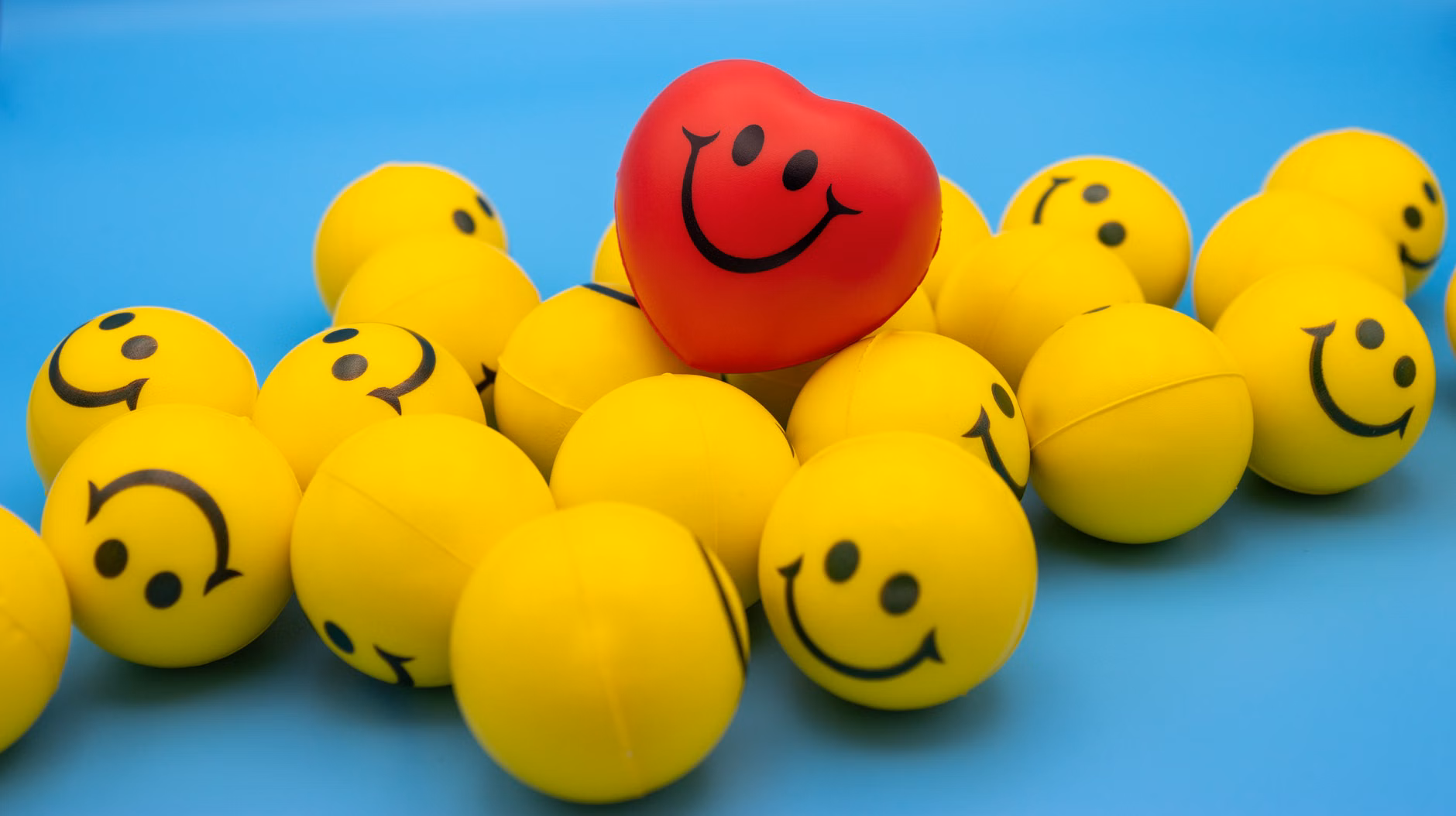 A set of color-coded resistance balls representing different levels of firmness for hand training.