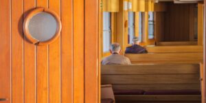 A senior couple enjoying the view from a cruise ship deck in a cold climate.