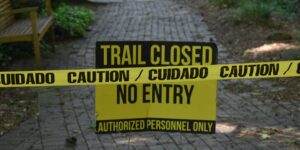 A scenic, accessible botanical garden pathway with clear signage and seating.