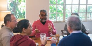 A group of seniors enjoying a wine tasting at a vineyard.