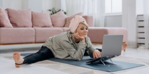 A senior adult practicing seated leg exercises for improved circulation at home.