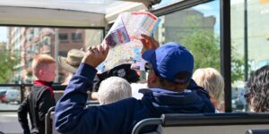 A group of older adults enjoying a guided city tour on a flat, accessible plaza.