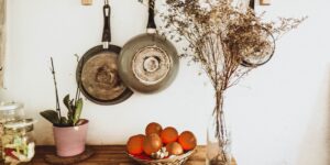 Fresh herbs hanging to dry in a sunlit home kitchen.