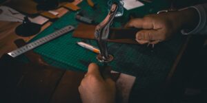 A close-up of skilled hands performing traditional bookbinding techniques.
