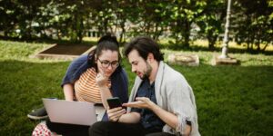 A couple discussing digital privacy on their devices in a bright, modern home office.