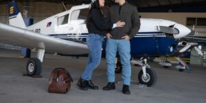 A senior couple preparing for a trip at an airport terminal with organized luggage.