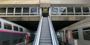 Modern train station platform with elevator access for travelers.