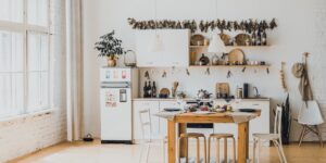 Sunlit kitchen scene featuring fresh herbs hanging to dry, representing a mindful and organized home preservation hobby.