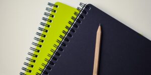 A professional setup for bookbinding featuring tools on a clean wooden desk.