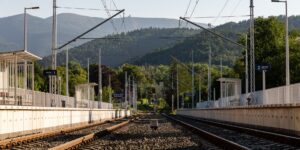 A scenic, accessible mountain train station platform during the day.