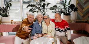 A group of older adults enjoying a birdwatching session in a park.