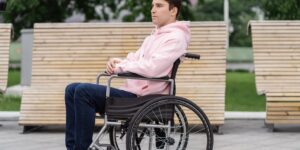 A modern, accessible public bench in a park setting.