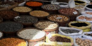 A variety of manganese-rich foods like nuts and seeds displayed on a wooden table.