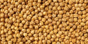 A diverse selection of nutrient-dense foods including legumes and grains on a wooden table.
