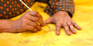 Close-up of hands performing traditional bookbinding techniques