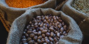 A selection of thiamine-rich whole foods like legumes, grains, and seeds on a kitchen counter.