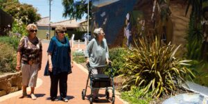 A group of active seniors walking together on a historical trail.