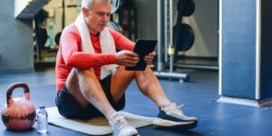 An older adult performing seated ankle-pumps to improve circulation in a comfortable home setting.