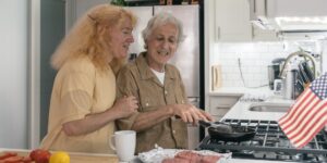 An active senior couple preparing a healthy, calcium-rich meal together in a bright kitchen.