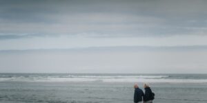 An older couple enjoying a walk on an accessible coastal path.