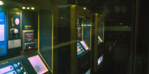 A senior couple interacting with a digital ticket kiosk in a modern museum.