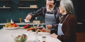 Healthy senior couple preparing a nutritious meal in a bright kitchen.
