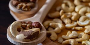A selection of selenium-rich whole foods like Brazil nuts and fish on a wooden table.