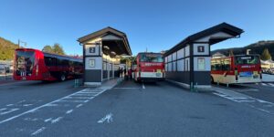 A bright, accessible rural bus terminal platform during the morning.