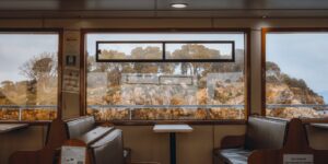 A modern and spacious river cruise cabin interior with a scenic river view.