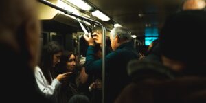 A group of older adults navigating a transit station using a smartphone.